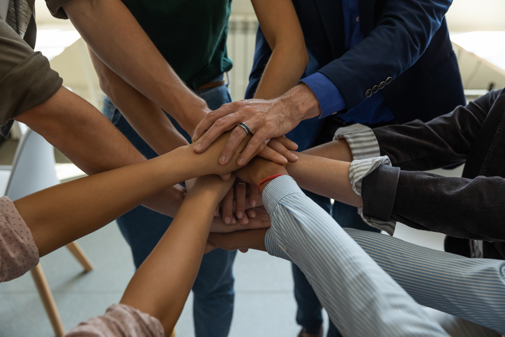 team-hands-atop-one-another