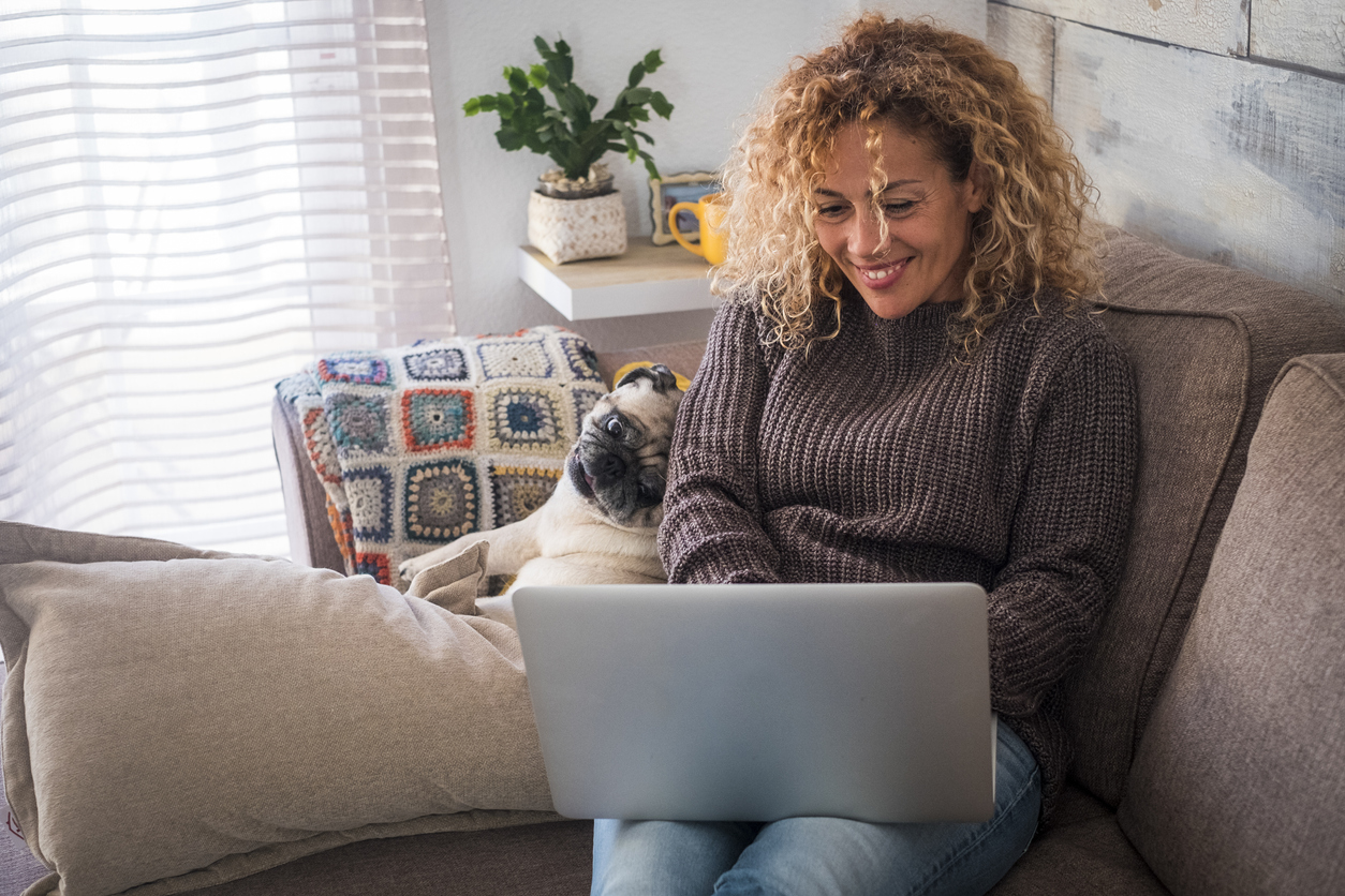 woman on couch using laptop