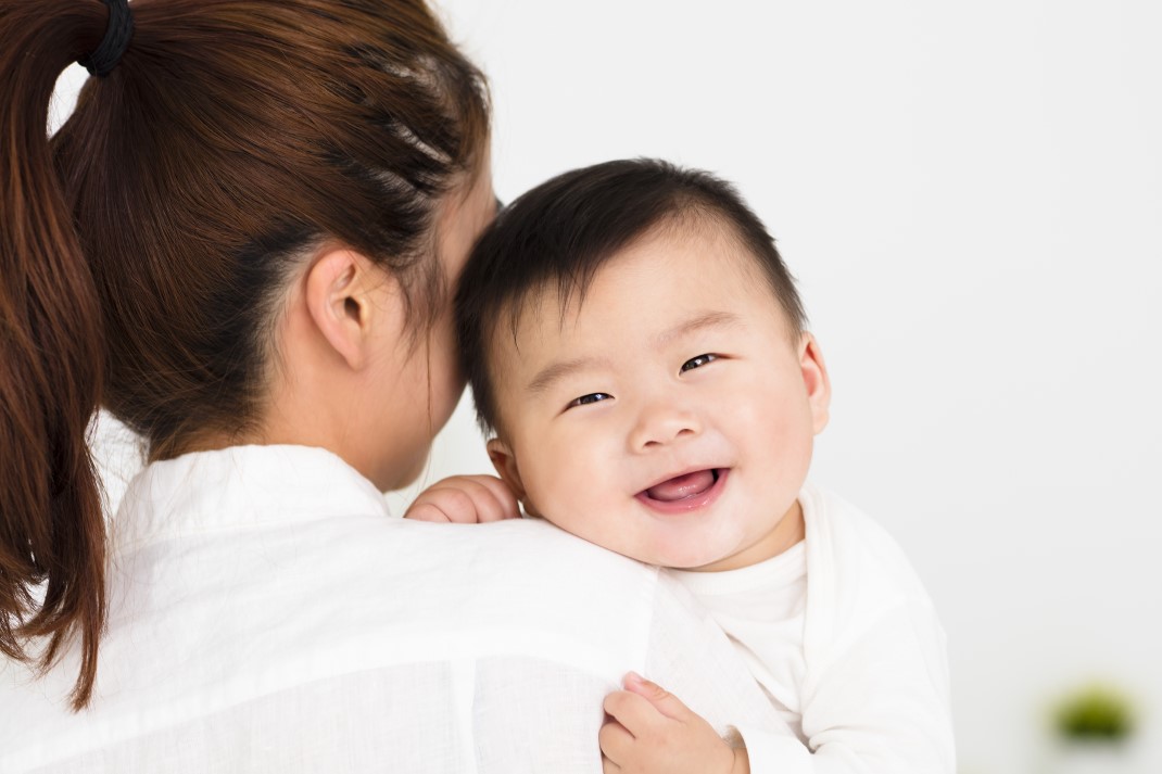 mother-holding-smiling-baby