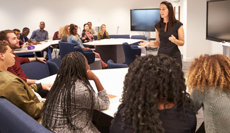 adults in a classroom watching female instructor