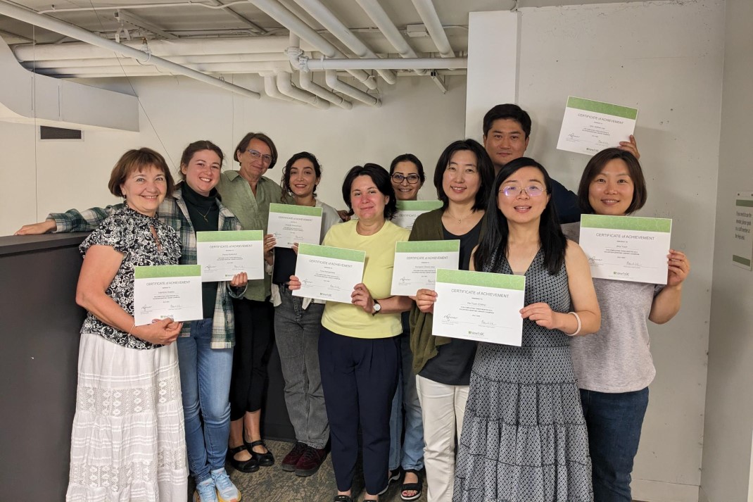 group of adults holding up certificates